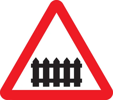 UK level crossing with barrier warning sign